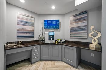 A modern kitchen with a countertop and a digital display on the wall. at 46 Penn Apartment Homes, Missouri